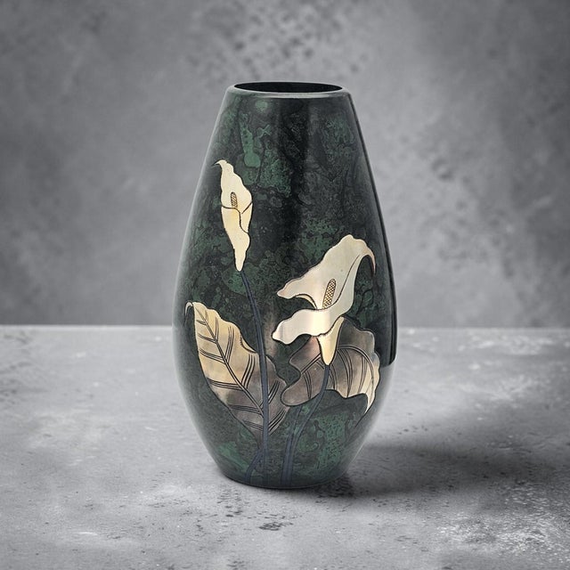 A refined example of Japanese Takaoka metalwork, this mid-century vase presents a classic tapered silhouette adorned with...