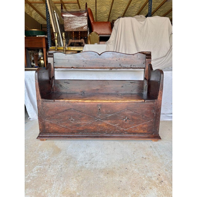Found in Italy, this 18th Century Italian Walnut Bench dates back to the late 1700's. The piece features a hand-carved...