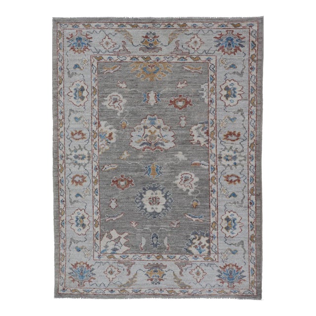 Floral Designed Oushak With Muted Background With Earthy Tones and Soft Blue For Sale