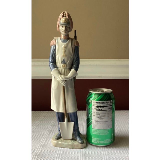 Vintage Lladro porcelain figurine #4839, handcrafted in Spain, depicting a solemn soldier in ceremonial uniform with a...
