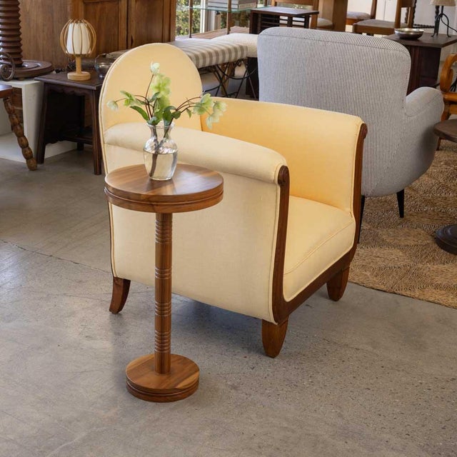 Solid walnut circular drink table with carved ribbed detailing, inspired by French design. Measures 23.25" H x 12" D....