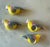 Set of 4 vintage hand carved and hand painted napkin rings in the shape of a yellow parrot with pink and blue accents.