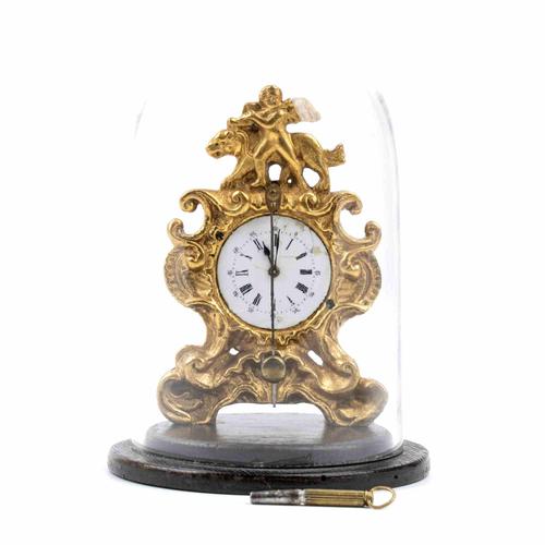 Shaped case in gilded bronze topped with a musician putto and a tiger, white enamel dial with Roman numerals and black...