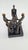An artistic bronze figurine (bronze alloy) depicting three stylized figures holding a common object, symbolizing...