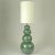 Pair of ceramic floor lights made of four globes that are descending in size and are stacked on top of each other to form...