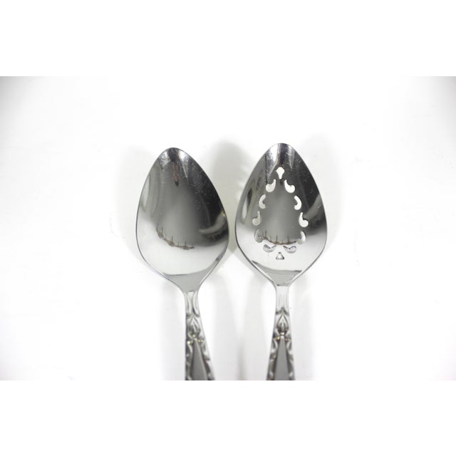 Fabulous, mid century modern set of two serving spoons. This is the Oneida Venetia pattern from the 1960’s. Great retro...