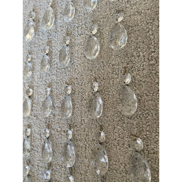 The product is a set of 42 vintage clear crystal chandelier prisms in teardrop and icicle shapes. These faceted crystals...