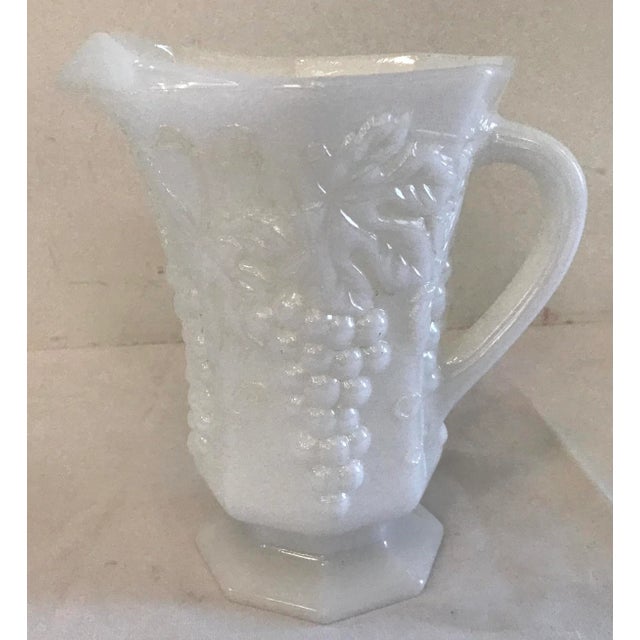 Lovely milk glass pitcher with a raised grape design!
