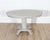 A Swedish oval center table from the early 20th century, circa 1900–1910, painted in a soft blend of green and grey that...