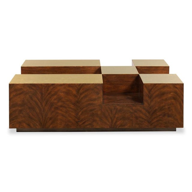 A curious modern low table elevated on a recessed plinth base with unlacquered brass panels on top and recesses for books...