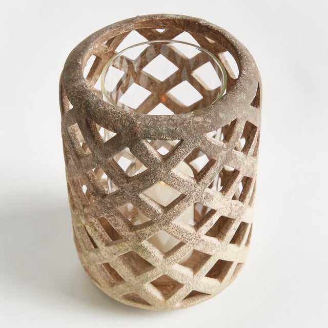 Expertly crafted from hand cut ceramic strips, and finished in a weathered moss terracotta finish, this hurricane lets all...