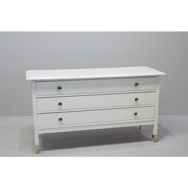 Carlo De Carli (Milan, 1910 - 1999) Model D154 chest of drawers in white lacquered wood, brass knobs and tops. Made by...