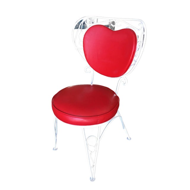 A set of four custom-made rod iron and steel rebar patio chairs with a distinct scrolling red heart backrest. They are in...