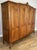 A beautifully crafted Vintage French Louis wardrobe, showcasing elegant flowing lines, rich oak grain, and finely carved...