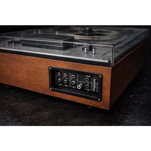 A beautifully preserved vintage Sony TC-630D reel-to-reel tape recorder, presented in its original wood cabinet with...