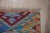 This multicolor jewel tone rug is crafted from wool using a durable flat weave technique. It represents a Kilim style...