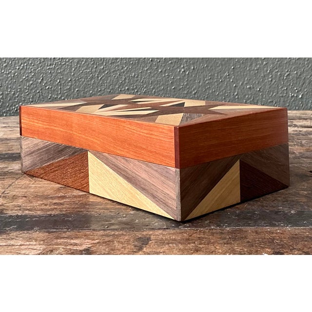 This exquisite vintage wooden box is a masterclass in artisanal parquetry, featuring a meticulously hand-assembled...