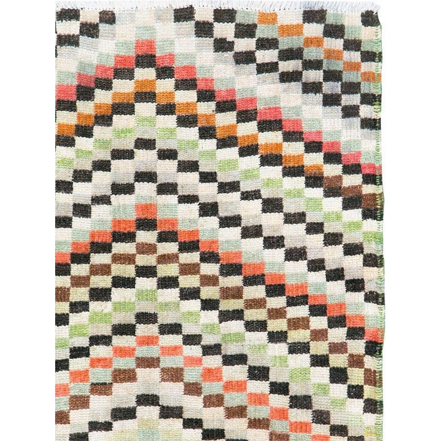 This Mid-20th Century Turkish Art Deco Style Anatolian rug presents a lively geometric composition built from small...