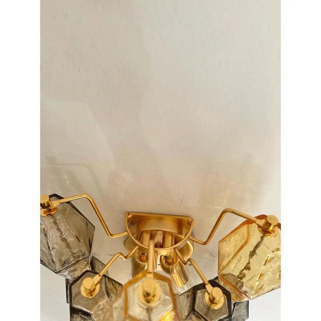 Contemporary and luxury wall sconces with amber and fumè “poliedri” murano glass in venini style. glass elements are blown...