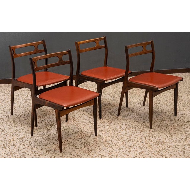 Johannes Andersen for Uldum Møbelfabrik, set of four dining chairs, model "138", teak, faux leather, Denmark, 1960s A set...