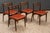 Johannes Andersen for Uldum Møbelfabrik, set of four dining chairs, model "138", teak, faux leather, Denmark, 1960s A set...