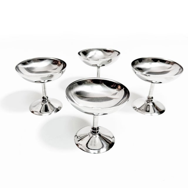 A sleek set of four vintage INOX 18/8 stainless steel coupes with the kind of polished, architectural profile that...