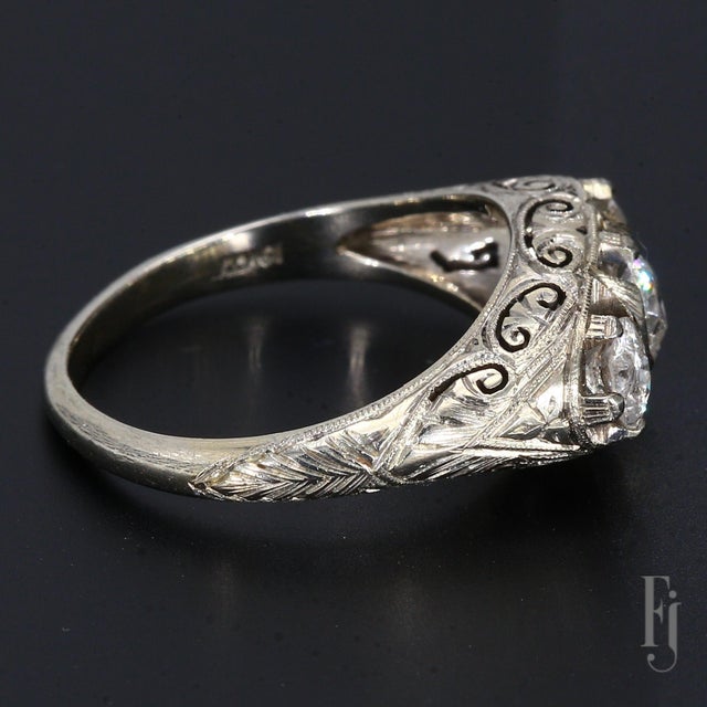 Here is an Antique 19k White Gold Filigree Design Ring with Three Diamonds, The Center Stone Weighs ~0.50cts & The Two...