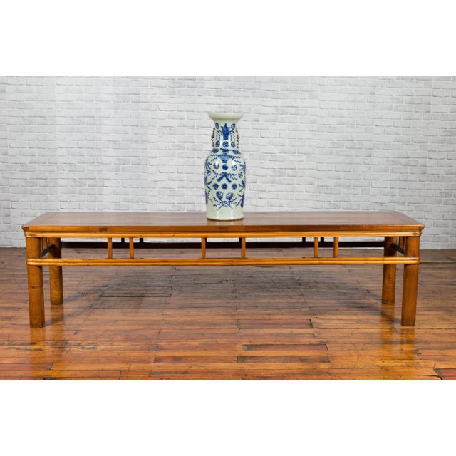 A Chinese late Qing Dynasty low table from the early 20th century, with pillar strut motifs and cylindrical legs. Probably...