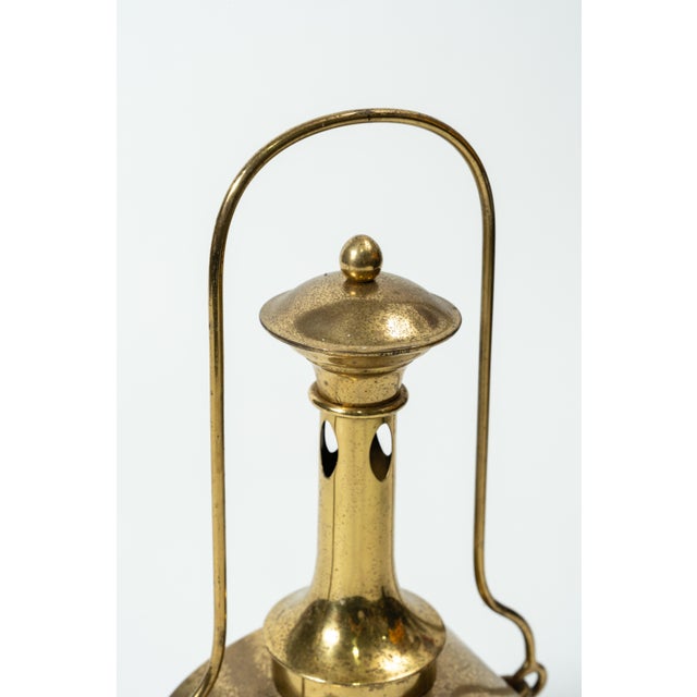 This remarkable brass lamp evokes the craftsmanship of the first half of the 20th century. Its design blends classic...