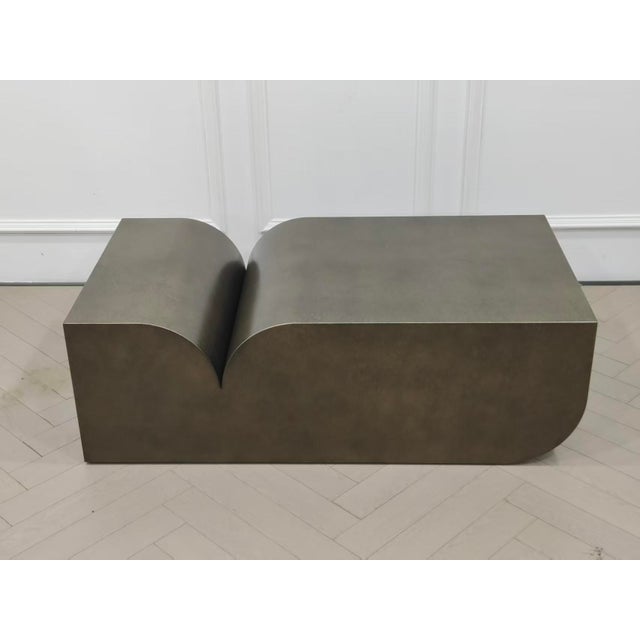 Elevate your living room with this unique sculptural coffee table which is a perfect fusion of modern elegance and...