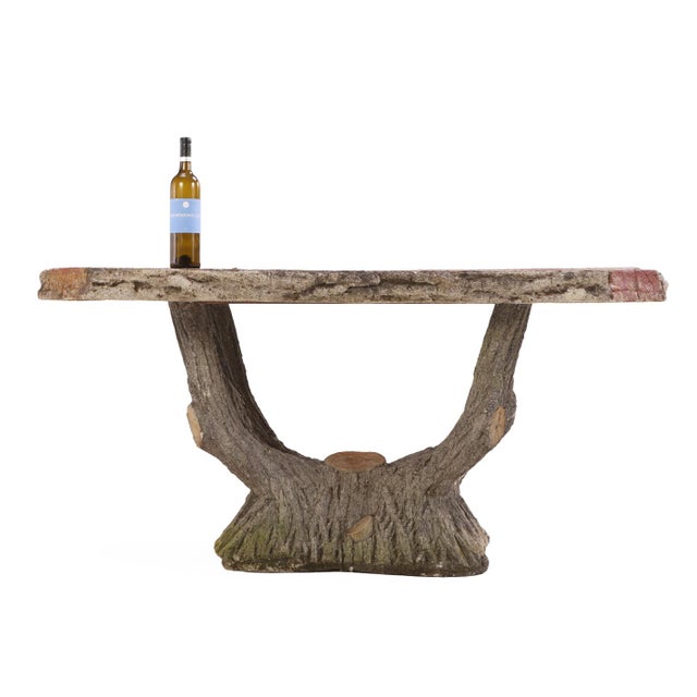 Cast stone faux bois garden table made in two pieces, featuring a slab-shaped top supported by a sculptural stump-form...