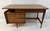 This mid-century modern style executive desk features four dovetail-jointed drawers floating atop elegant, brass-foot...