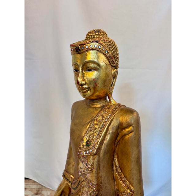 Gracefully standing over thirty-three inches in height, this finely hand-carved Burmese Mandalay Buddha possesses a...