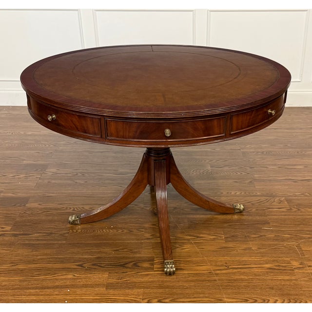 This is a Classic Traditional Round Mahogany Drum Table by Leighton Hall. It features a leather top, four dovetailed...