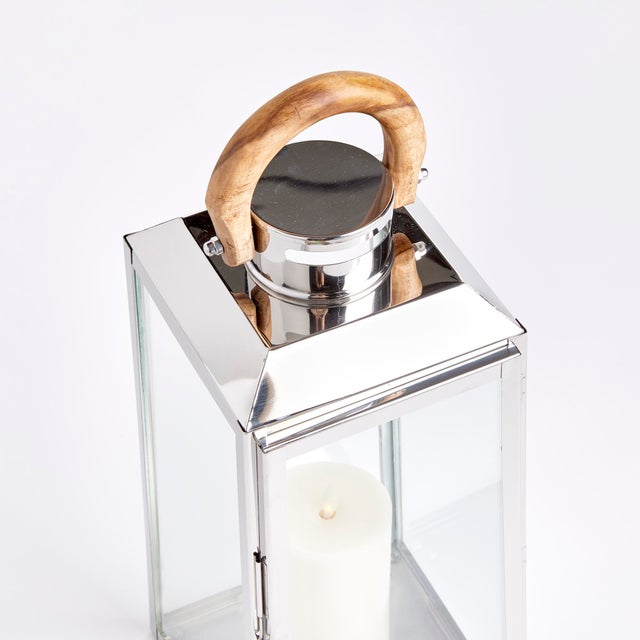 Nautical in style, this handsome outdoor lantern shines brilliantly in a chrome finish and real teak wood handle. Add a...
