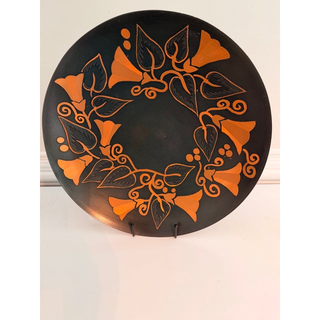 A striking pair of large vintage handmade copper decorative plates from Chile, each measuring approximately 15 inches in...