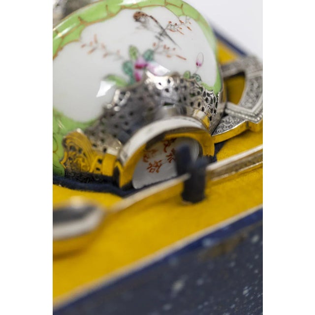 Tea service composed of six cups in fine Indonchinese porcelain. The celadon-color cups are adorned with floral and birds...