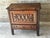 Small carved oak storage cabinet, circa 1930. It opens with a lockable drop-front, featuring an interior shelf and a wide...