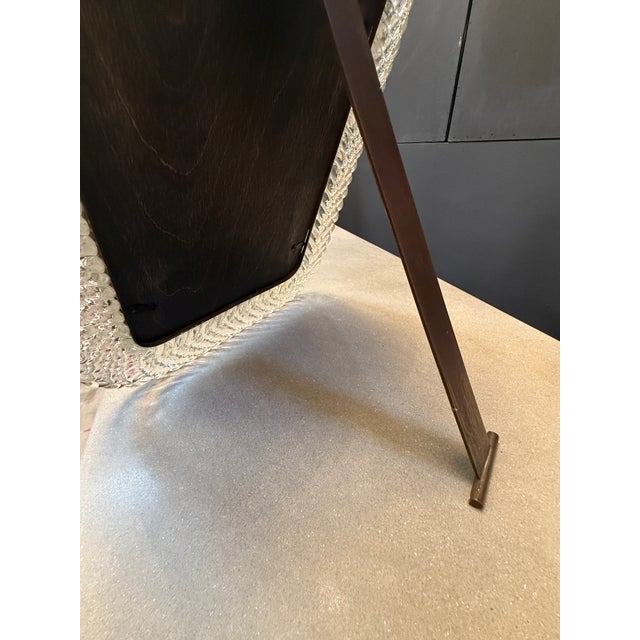 An elegant mid-20th century Italian table mirror crafted in handblown Murano glass. The clear glass frame features a...