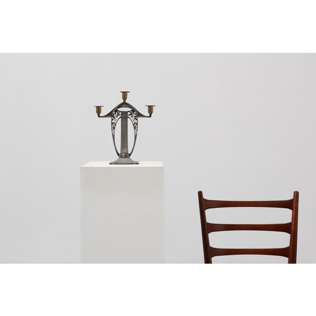 A refined example of jugendstil metalwork, this three‑arm candelabrum by wmf (württembergische metallwarenfabrik) captures...