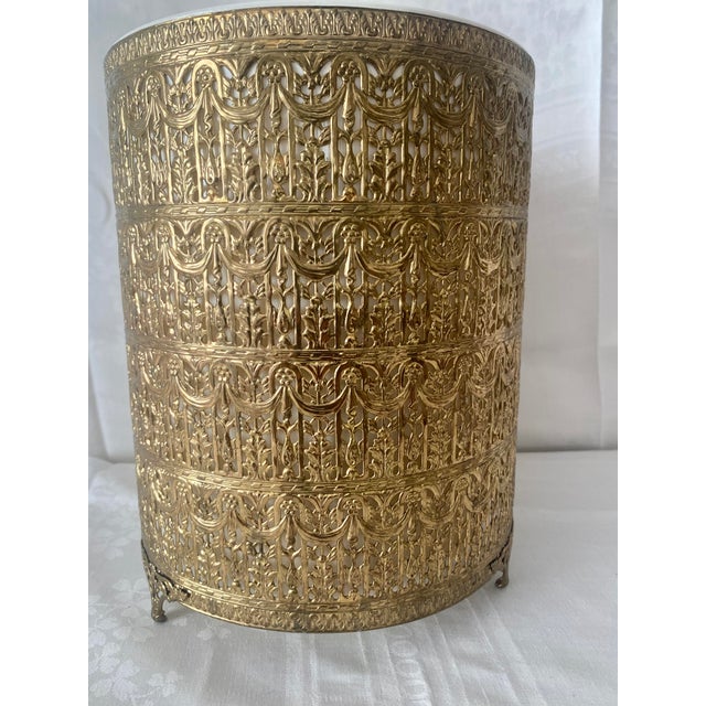 Stunning Vintage Hollywood Regency style gold tone wastebasket features an exceptionally ornate, tiered gilt metal French...
