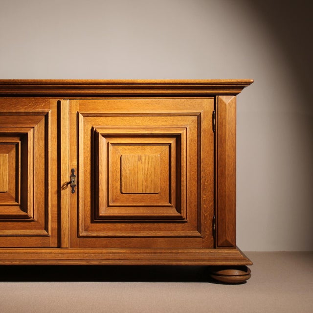 ​For sale is a sculptural oak sideboard dating back to the 1970s. This model features a brutalist design language with...