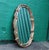 This large vintage Regency style mirror has a unique scalloped oval frame of painted gold wood. Carved ornate...