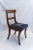 A set of 4 late Victorian mahogany dining chairs featuring floral needlepoint navy blue seats. One captain chair with arm...
