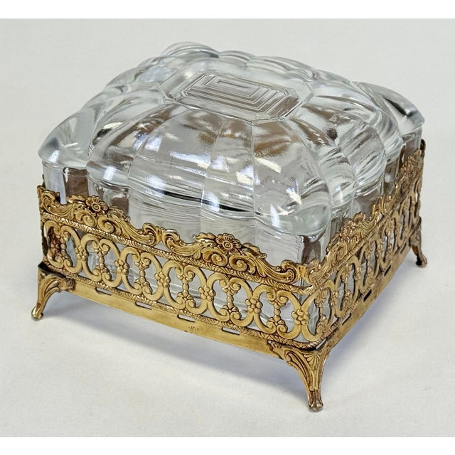 Stunning vintage Hollywood Regency style glass trinket box with footed brass filigree base. Glass box itself 4.5"W x 4"D x...