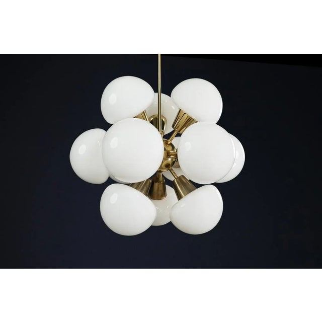 Mid-century modern sputnik chandelier in brass and opaline glass, czech republic, 1970s a striking example of 1970s...