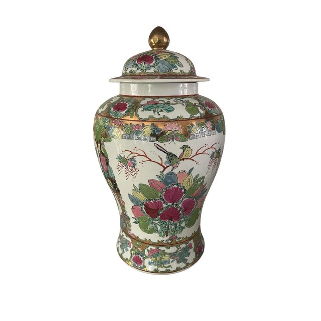 Stunning tall Famille Rose Chinese porcelain ginger jar with a fitted lid. This impressive piece measures approximately 12...