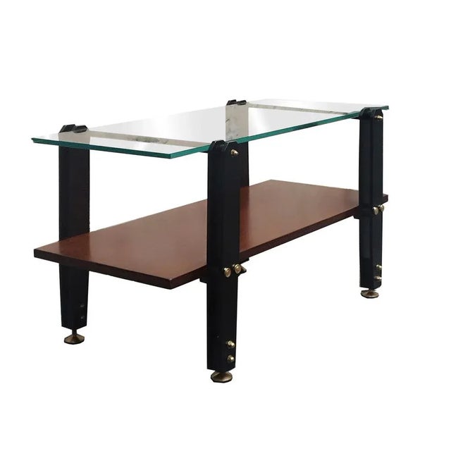 Low Italian wooden coffee table,brass and metal frame, with a thick glass top.
