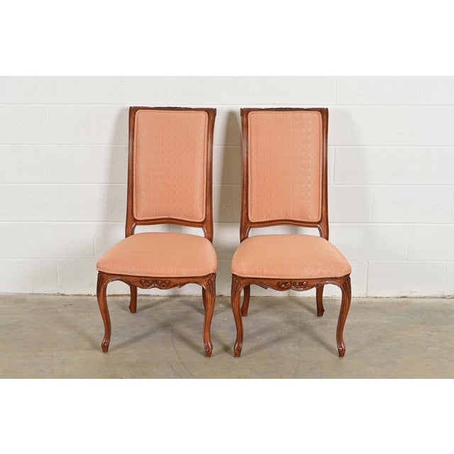 An outstanding pair of French Rococo or French Provincial Louis XV style side chairs or dining chairs By Baker Furniture...