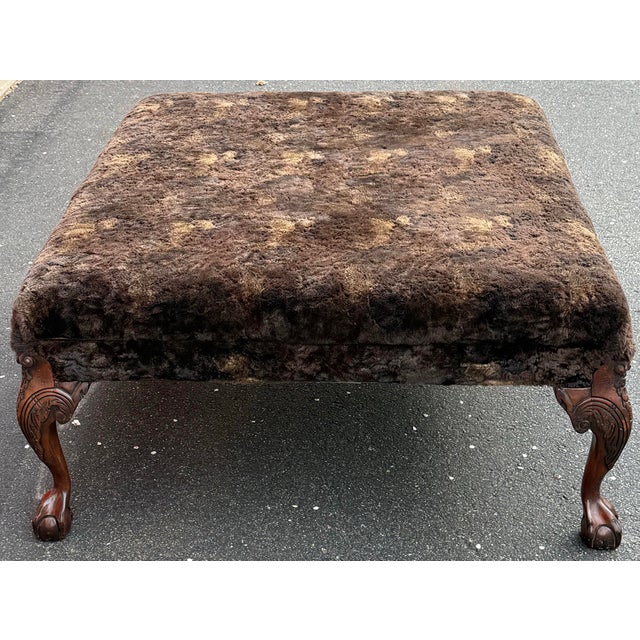 Generously proportioned ottoman by Old Hickory tannery. Features faux fur upholstery and elegant cabriole legs with ball...